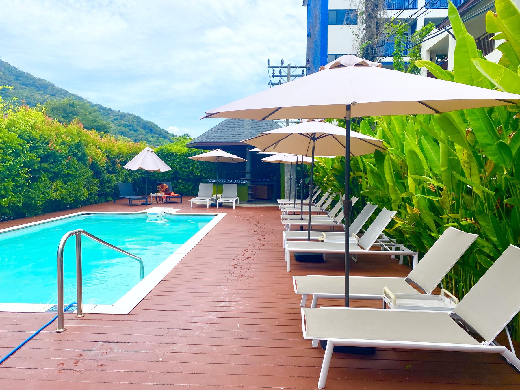 Garden pool with loungers at Spice and Sea