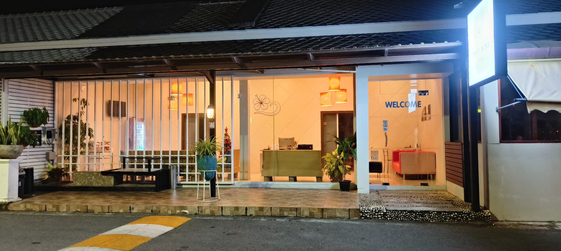 Reception entrance at night with the welcome sign